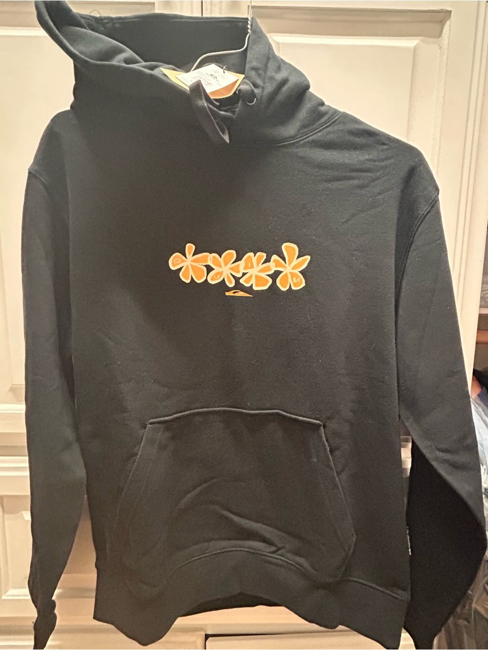 Men's/ Teen Black Quicksilver Hoodie with Orange Floral Graphic.